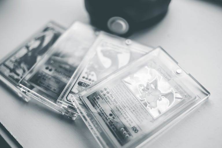 Close-up of collectible Pokemon cards in protective cases, emphasizing preservation and value.
