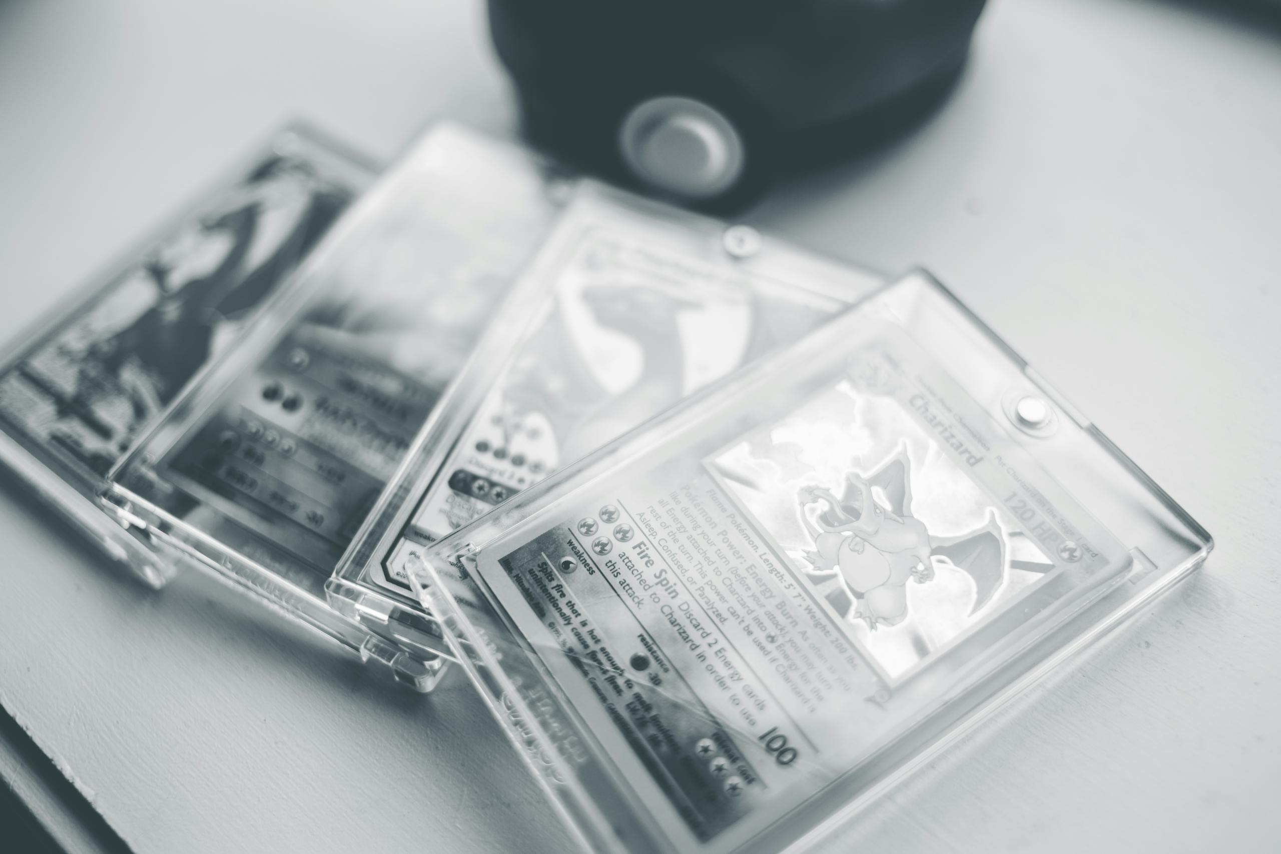 Close-up of collectible Pokemon cards in protective cases, emphasizing preservation and value.