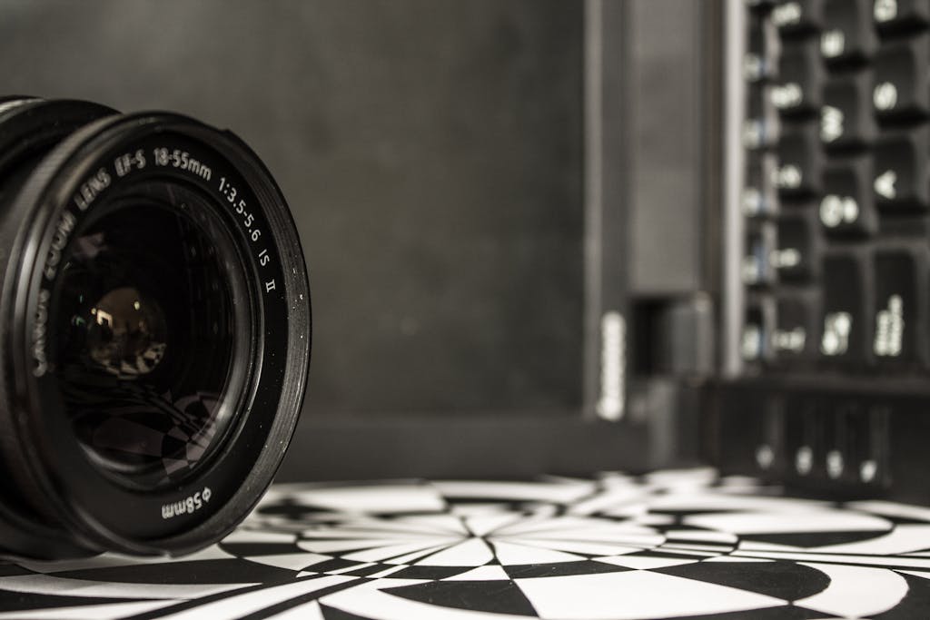 Detailed shot of a camera lens near a laptop keyboard, showcasing optical technology.