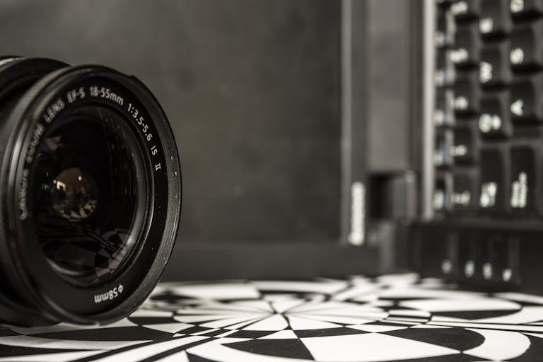 Detailed shot of a camera lens near a laptop keyboard, showcasing optical technology.